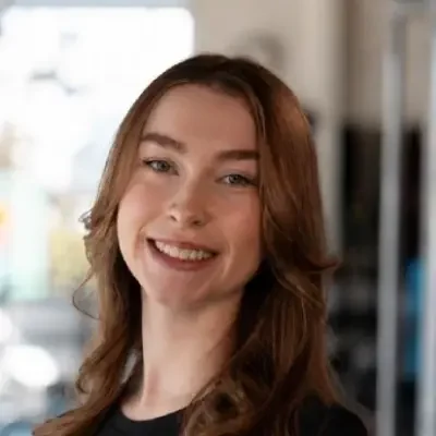 staff member in black tshirt and smiling with brown hair